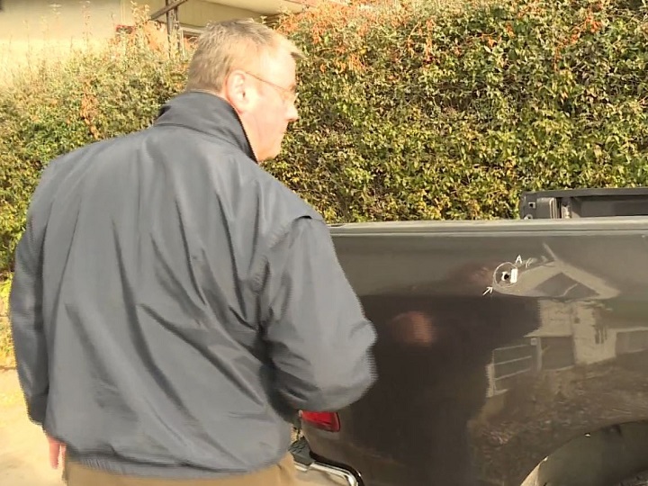 Brad Albrecht looks at his truck, and the bullet hole in the box, following an unconfirmed drive-by shooting in Vernon on Friday afternoon.