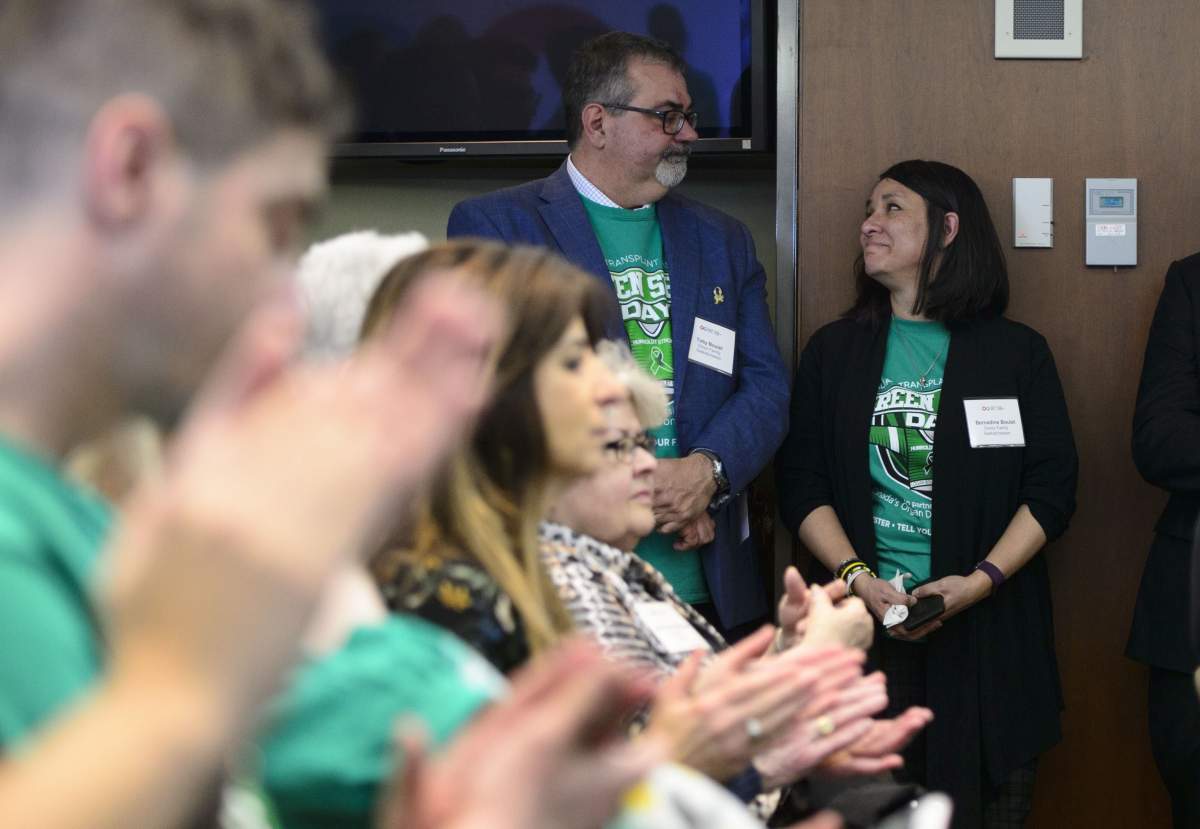 Toby and Bernadine Boulet look at one another as they are recognized during an event for Green Shirt Day and National Organ and Tissue Donation Awareness Week in Ottawa on April 3, 2019.