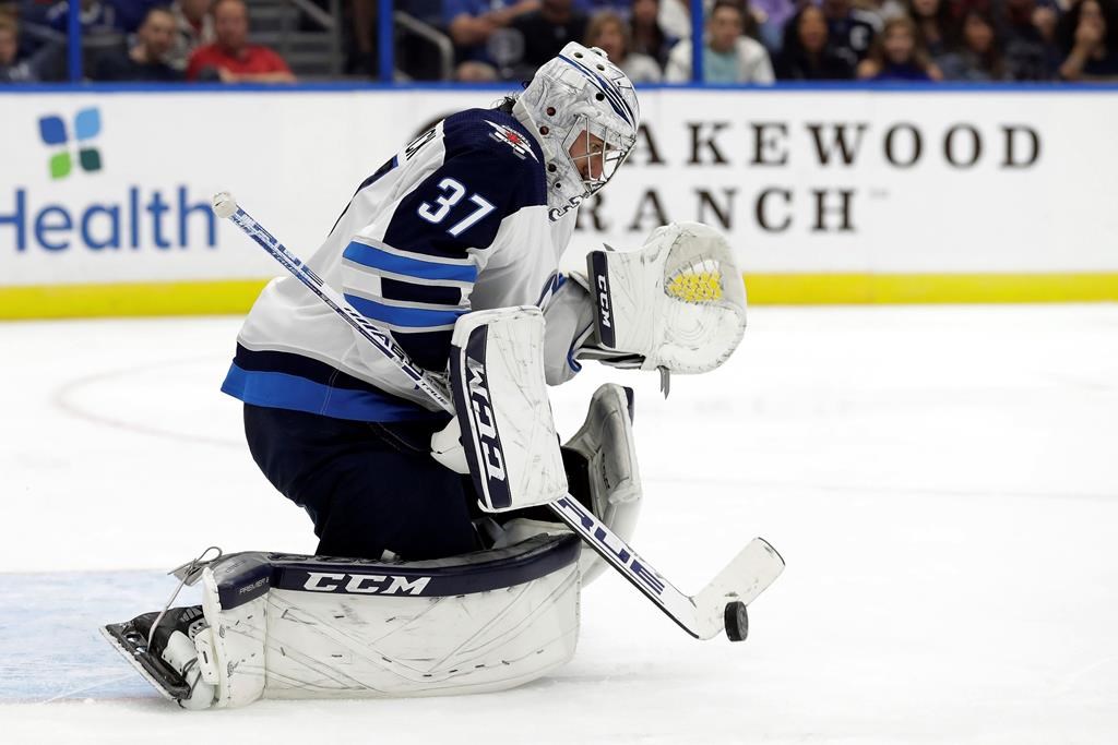Winnipeg Jets goaltender Connor Hellebuyck (37) makes a save on a shot by the Tampa Bay Lightning during the second period of an NHL hockey game Saturday, Nov. 16, 2019, in Tampa, Fla. (AP Photo/Chris O'Meara).