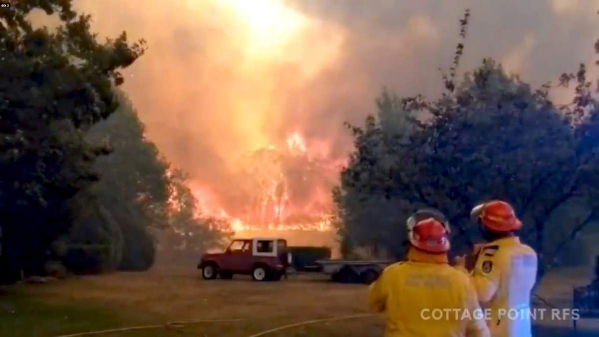 FILE PHOTO: Firefighters work at the scene of a bushfires in Bilpin, New South Wales, Australia in this still image from a social media video December 15, 2019.   