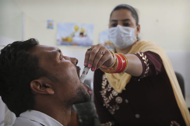 In this Thursday, Oct. 31, 2019, photo, a medic administers medicine to a recovering drug addict at a de-addiction center in Kapurthala, in the northern Indian state of Punjab.