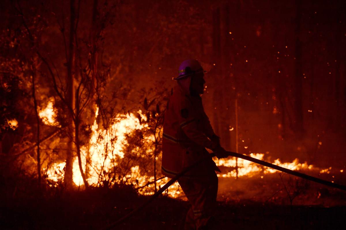 A Rural Fire Service (RFS) firefighter conducts mopping up near the town of Sussex Inlet on Dec. 31, 2019 in Sydney, Australia.