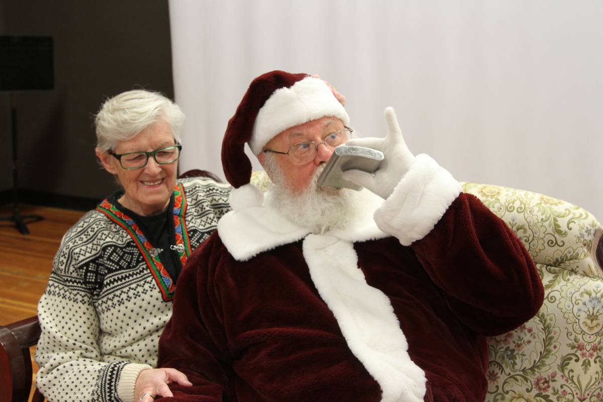 Gary Haupt pretends to drink from a flask at the Shatford Centre Christmas market.