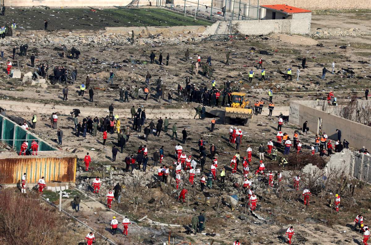 Rescue workers search the scene where an Ukrainian plane crashed in Shahedshahr, southwest of the capital Tehran, Iran, Wednesday, Jan. 8, 2020. (AP Photo/Ebrahim Noroozi)