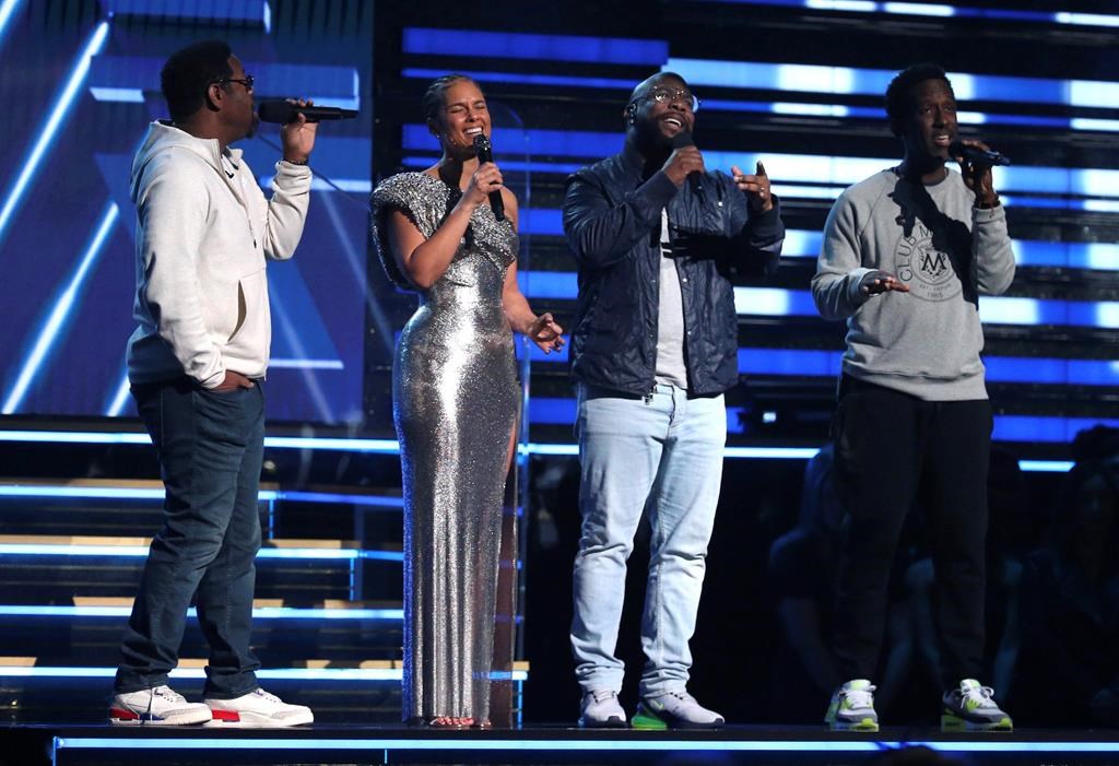 Nathan Morris, from left, Wanya Morris, Shawn Stockman of Boyz II Men and Alicia Keys sing a tribute in honour of the late Kobe Bryant at the 62nd annual Grammy Awards on Sunday in Los Angeles, Calif.