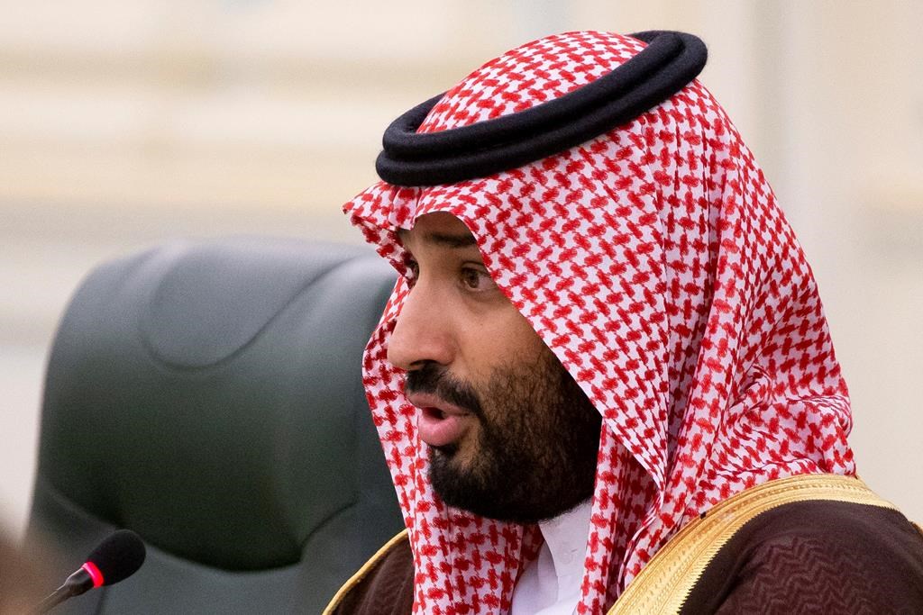 FILE - In this Oct. 14, 2019 file photo, Saudi Arabia's Crown Prince Mohammed bin Salman speaks to Russian President Vladimir Putin during the talks in Riyadh, Saudi Arabia.