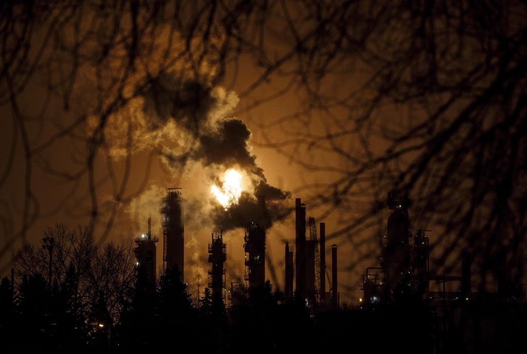 A flare stack lights the sky along refinery row in Edmonton, Alta., on Friday, Dec. 28, 2018.