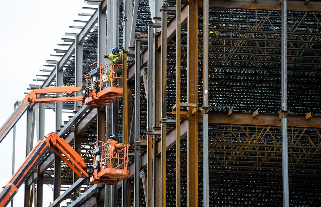 Steel workers build a structure in Ottawa on March 5, 2018. Canada saw its first monthly jobs gain since September last month, according to new labour data. THE CANADIAN PRESS/Sean Kilpatrick.