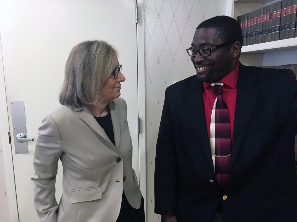 Sauntore Thomas, right, and his lawyer, Deborah Gordon, left, talk, Thursday, Jan. 23, 2020 in Bloomfield Hills, Mich.