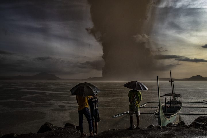 Residents look on as Taal Volcano erupts on Jan. 12, 2020 in Talisay, Batangas province, Philippines.