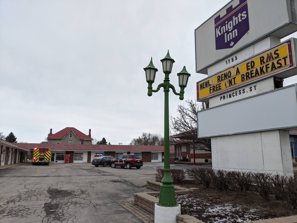 A Kingston woman has been charged for allegedly lighting a fire in a motel room as her on-again off-again partner lay inside sleeping.