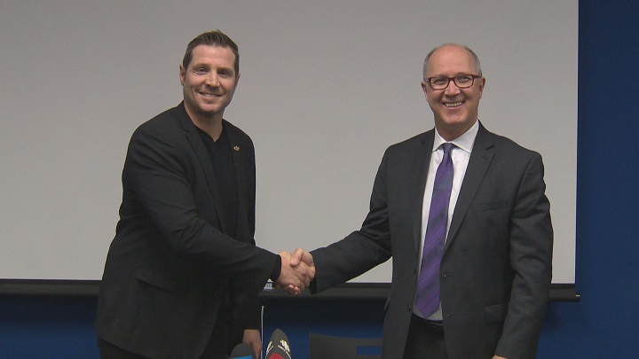 Outgoing MJHL commissioner Kim Davis (left) welcomes new commissioner Kevin Saurette (right).