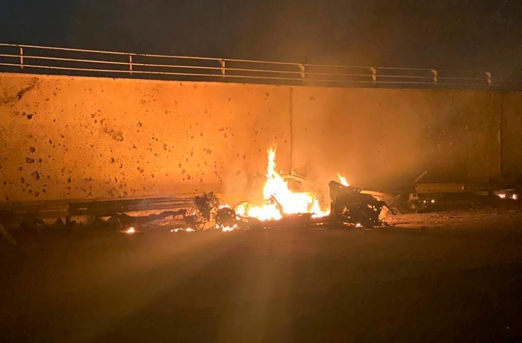 This photo released by the Iraqi Prime Minister Press Office shows a burning vehicle at the Baghdad International Airport following an airstrike in Baghdad, Iraq early Friday, Jan. 3, 2020.
