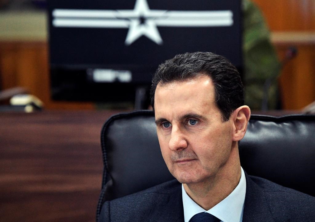 Syrian President Bashar Assad listens to Russian President Vladimir Putin during their meeting in Damascus, Syria, Jan. 7, 2020.