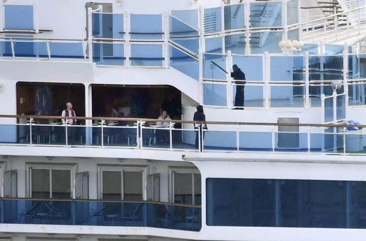 People on board cruise ship Diamond Princess anchored off the Yokohama Port, are pictured in Yokohama, Japan in this photo taken by Kyodo Feb. 4, 2020.