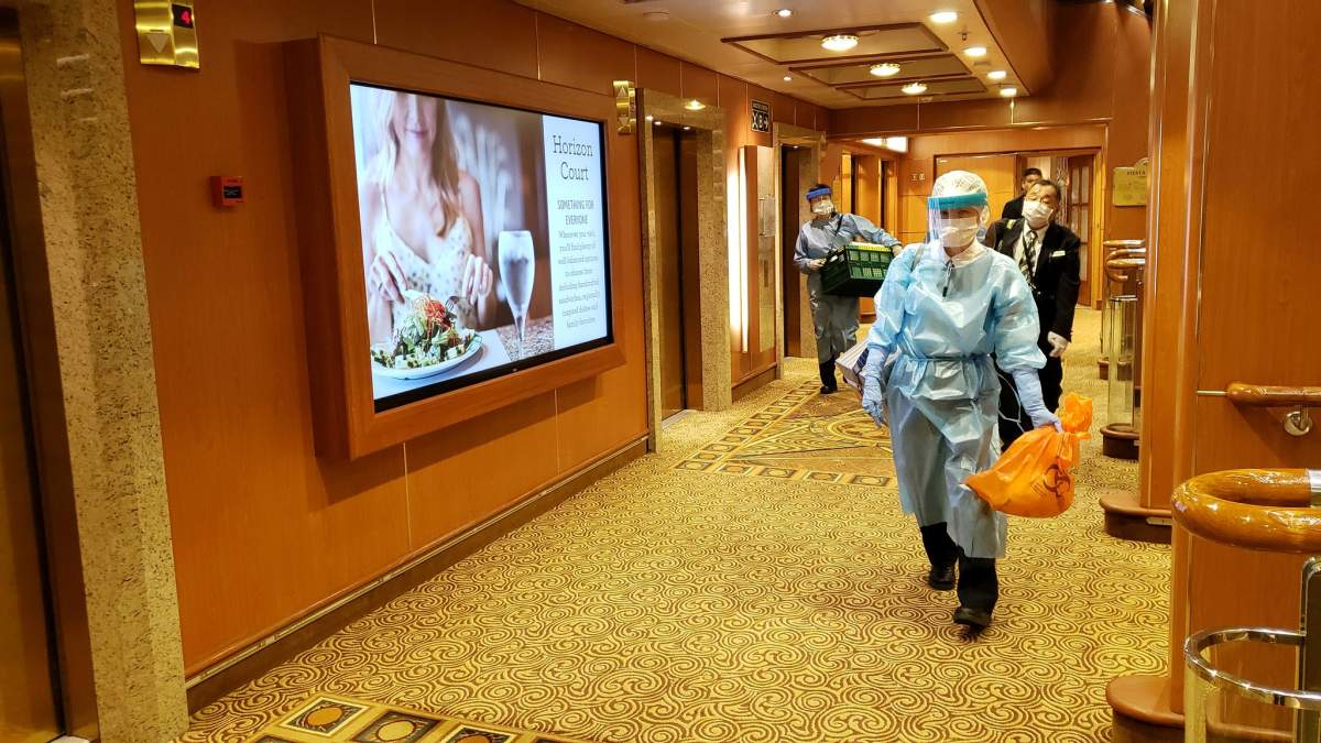 A man in protective clothing is seen on the sixth deck of the cruise ship Diamond Princess in Yokohama, in this Feb. 4, 2020 photo obtained from social media.