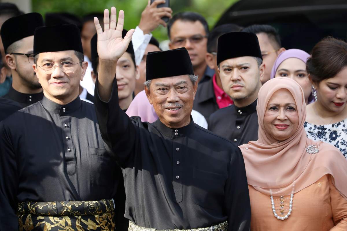 Malaysia's Prime Minister Designate and former interior minister Muhyiddin Yassin waves to reporters before his inauguration as the 8th prime minister, outside his residence in Kuala Lumpur, Malaysia, March 1, 2020.  