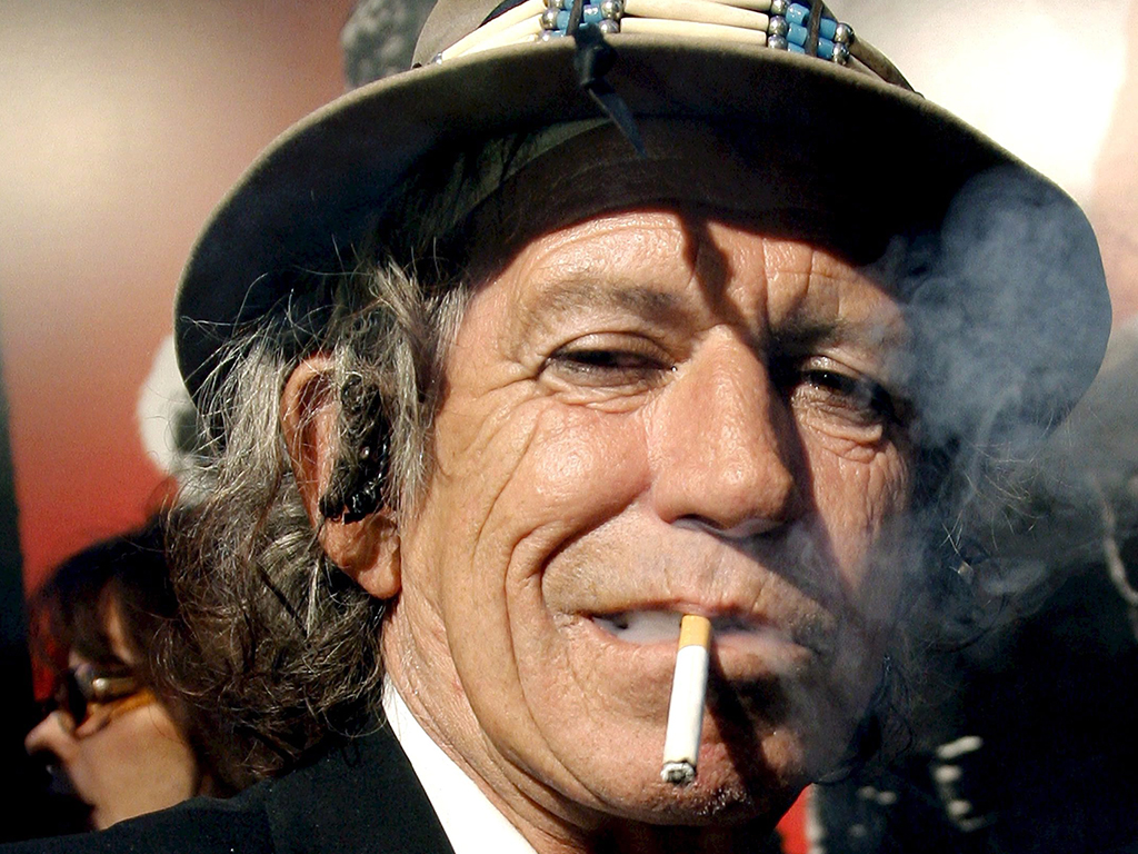A file picture dated March 30, 2008 shows Rolling Stones guitarist Keith Richards smoking a cigarette at the Ziegfeld Theater in New York City. 