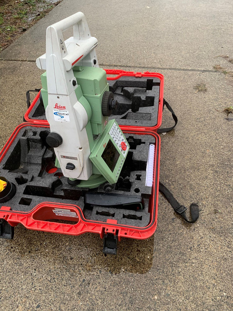 One of the stolen items is a Leica Viva TS16 total station (serial number 3010318). It is green with a white handle and in a bright red case
