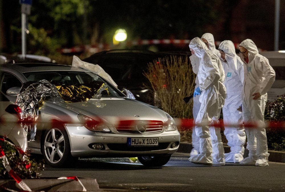 Forensics investigate at the scene after a shooting in central Hanau, Germany Thursday, Feb. 20, 2020. Eight people were killed in shootings in the German city of Hanau on Wednesday evening, authorities said. (AP Photo/Michael Probst)