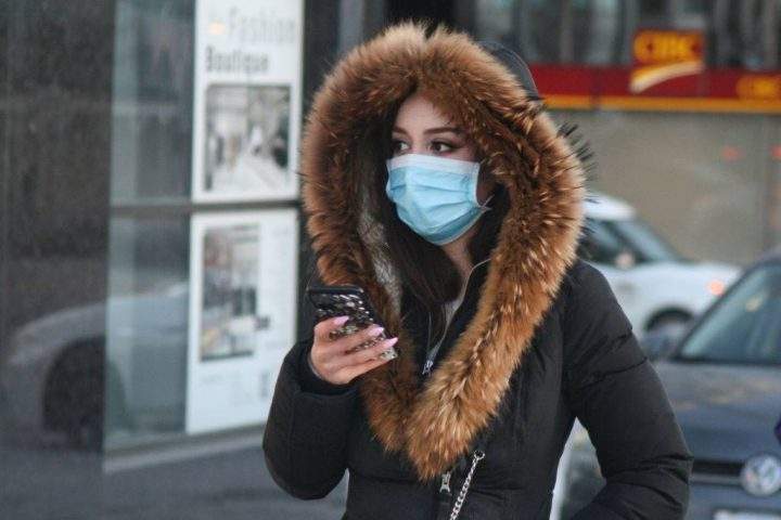 FILE PHOTO: A pedestrian wears a face mask in Toronto on Jan. 29, 2020.