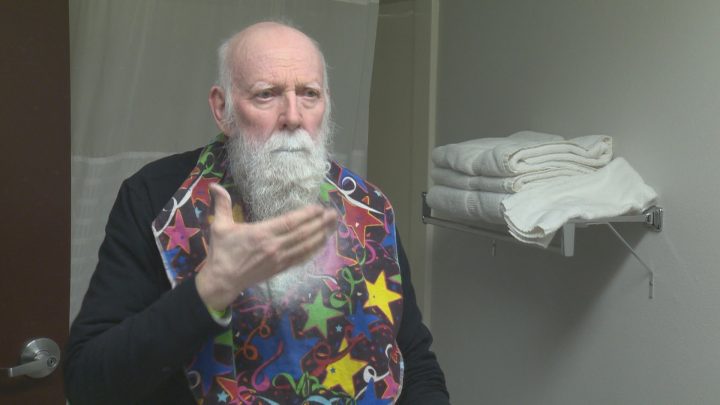 Madsen spray paints his beard white before using stencils to create logos.