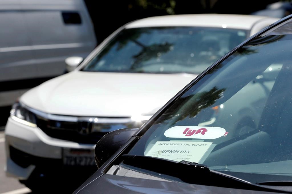 FILE - In this July 9, 2019, file photo a Lyft ride-share car waits at a stoplight in Sacramento, Calif.