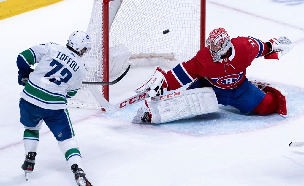 Vancouver Canucks' Tyler Toffoli scores past Montreal Canadiens goaltender Carey Price during overtime NHL hockey action in Montreal, Tuesday, Feb. 25, 2020. THE CANADIAN PRESS/Paul Chiasson.
