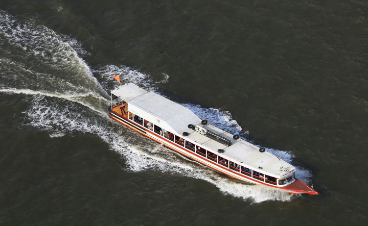 A water taxi travels on the Chao Phraya River, running through the Thai capital of Bangkok, in Bangkok, Thailand, on May 13, 2016.