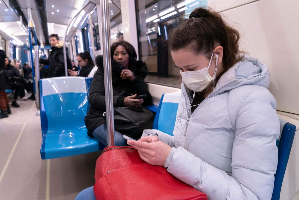 A commuter wears a protective mask as she rides the metro in Montreal on Friday, March 13, 2020. The official opposition is hoping to pass a motion to make masks mandatory on public transit as Quebec gradually re-opens amid pandemic. Wednesday, May 6, 2020.
