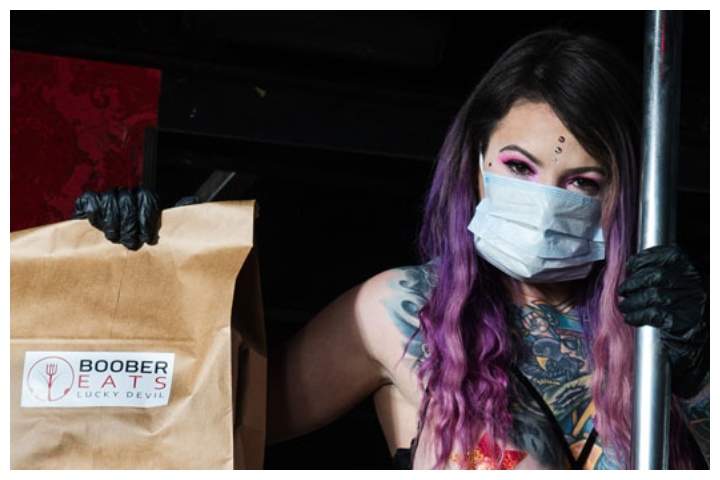 Brodie Grody, a dancer at Lucky Devil Lounge in Portland, Ore., poses with a Boober Eats delivery bag.