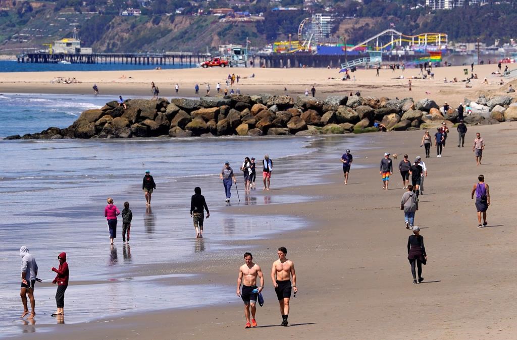Beachgoers are seen at Venice Beach, Saturday, March 21, 2020, in Los Angeles, Calif.