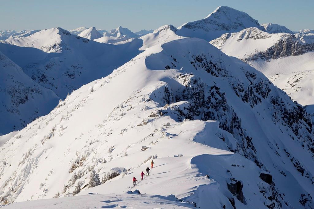 Backcountry skiers are dwarfed by the mountains as they make their way along a mountain ridge near McGillivray Pass Lodge located in the southern Chilcotin Mountains of British Columbia, on January 10, 2012. Rescue officials are asking backcountry users to choose low-risk activities as the risk for COVID-19 grows. The warning comes after the Alberta government asked ski hills in the province to close to prevent the spread of the novel coronavirus. THE CANADIAN PRESS/Jonathan Hayward.