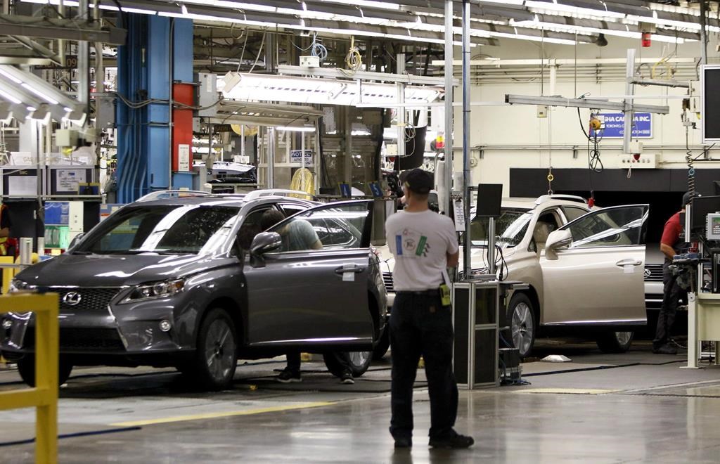 Line workers assemble a Lexus SUV at the Toyota plant in Cambridge, Ont., Friday, July 31, 2015.