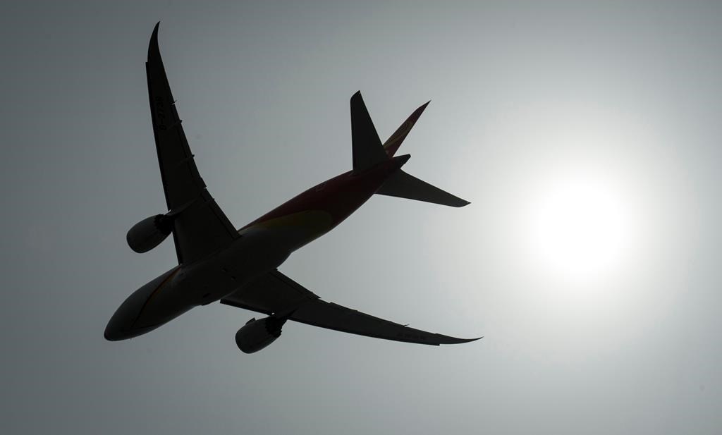 A plane is silhouetted as it takes off from Vancouver International Airport in Richmond, B.C., on May 13, 2019.