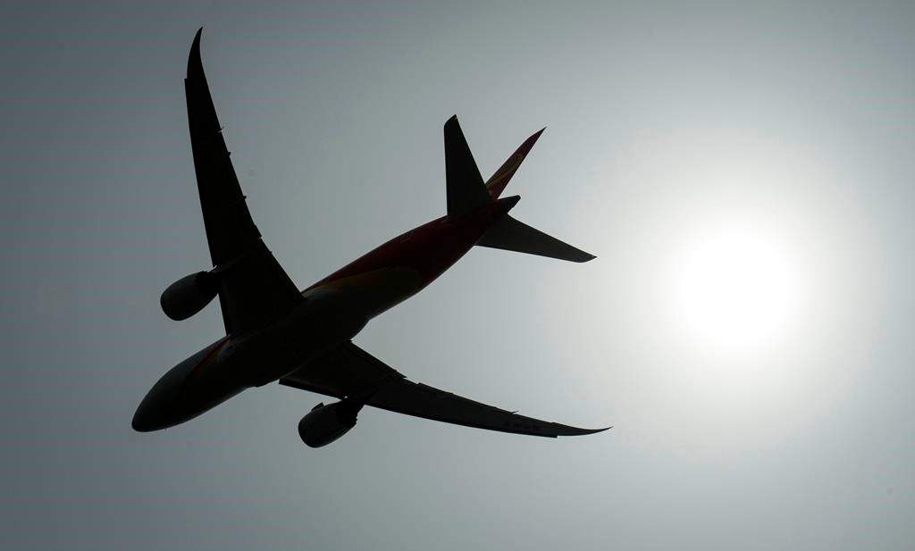 A plane is silhouetted as it takes off from Vancouver International Airport in Richmond, B.C., on May 13, 2019. The Federal Court of Appeal has dismissed an attempt by airlines to suspend the country's new passenger rights charter. The judge turned down Tuesday a motion by Air Canada, Porter Airlines Inc. and 14 other carriers to freeze the traveller protections until an appeal of the regulations is heard. Justice David Near said the appellants did not show on a balance of probabilities that the rules would cause irreparable harm. THE CANADIAN PRESS/Jonathan Hayward.
