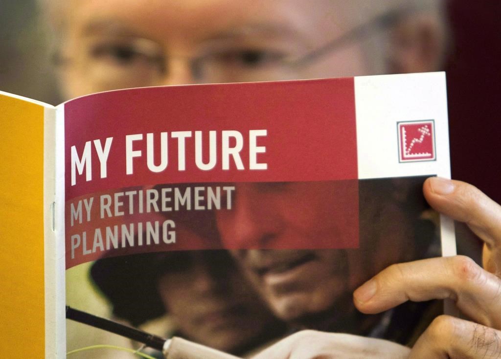 A man looks over a brochures offering various retirement savings options Friday, February 3, 2012 in Montreal. There are many reasons for starting Canada Pension Plan payments as early as age 60 - but only a few of them are good reasons, financial planners say. THE CANADIAN PRESS/Ryan Remiorz.