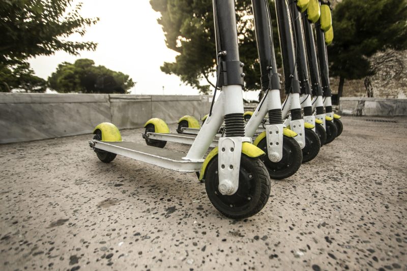 Group of electronic scooters on the street.
