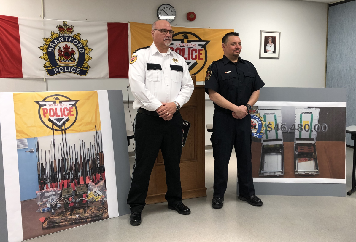 Six Nations Police inspector Darren Montour (left) and Brantford Police Chief Rob Davis (right) announced that two Ohsweken men are facing hundreds of charges in connection with three dozen ATM thefts across southern Ontario.