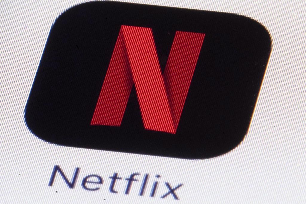 The Netflix logo is shown on an iPhone in Philadelphia on Monday, July 17, 2017. Netflix is lowering video quality for its subscribers in Canada as the streaming giant attempts to reduce soaring demands on internet bandwidth. THE CANADIAN PRESS/AP, Matt Rourke.