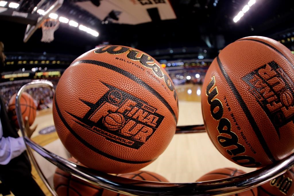 FILE - In this April 3, 2015, file photo, basketballs sit in a rack.