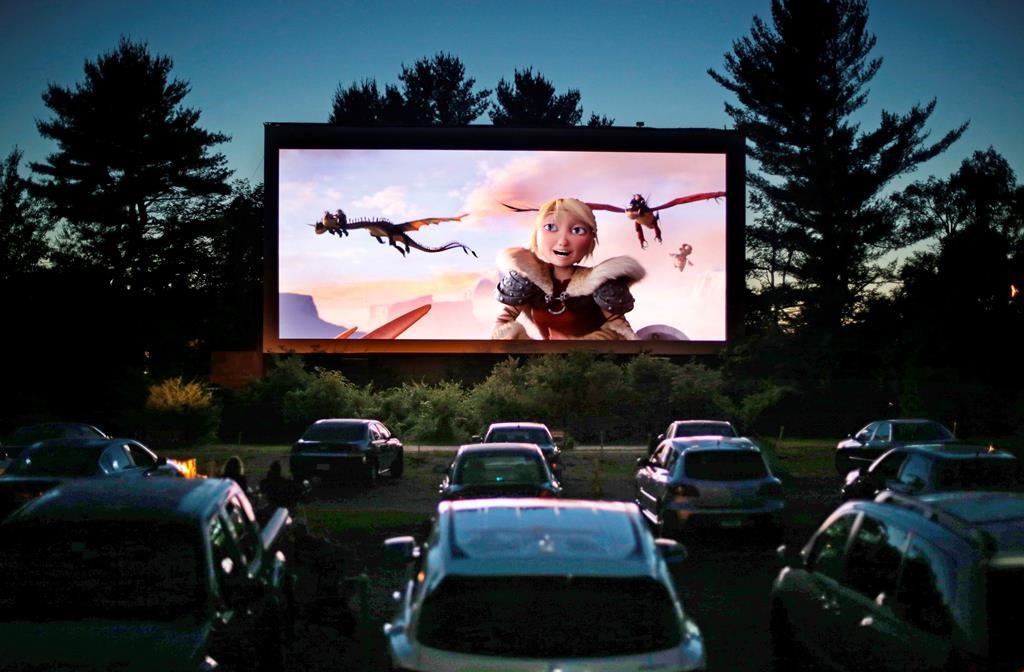 FILE - In this June 26, 2014, file photo, movie-goers watch "How to Train Your Dragon 2,".