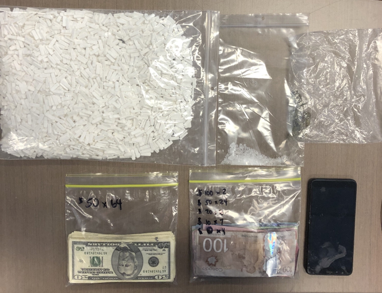 A vehicle search found thousands of pills, the counterfeit cash, which was both Canadian and U.S. currency, and a small amount of methamphetamine.