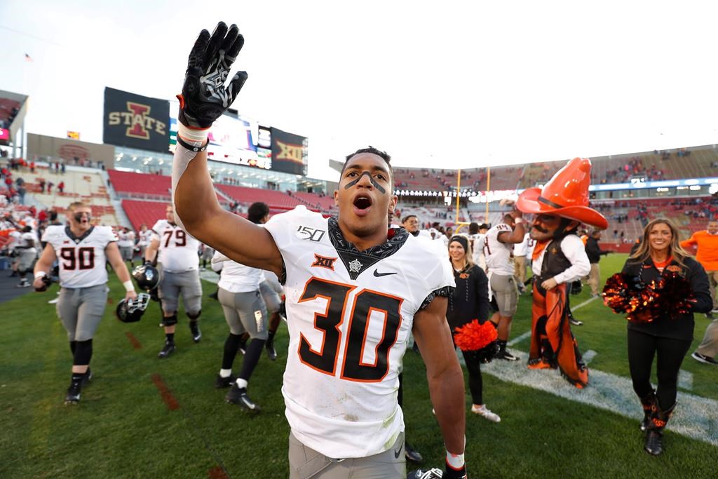 Oklahoma State running back Chuba Hubbard blows a kiss to Oklahoma State fans after their 34-27 win over Iowa State in an NCAA college football game in Ames, Iowa, on Oct. 26, 2019. Canadian Chuba Hubbard will have a tough act to follow this season. His own. The 20-year-old native of Sherwood Park, Alta., was the NCAA rushing leader last season, running for 1,936 yards and 21 TDs. That left the Oklahoma State star eighth in voting for the Heisman Trophy, presented annually to American college football's top player. THE CANADIAN PRESS/AP - Matthew Putney.
