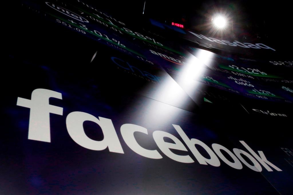 In this March 29, 2018 photo, the logo for Facebook appears on screens at the Nasdaq MarketSite in New York's Times Square.