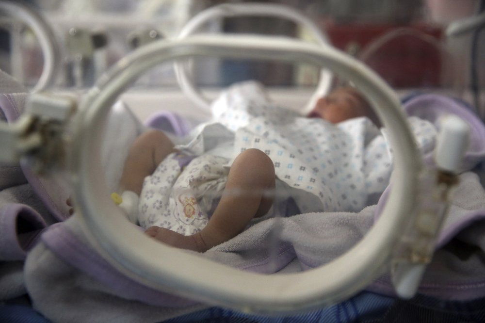 Newborn babies lie in their cribs at the Ataturk Children's Hospital a day after being rescued from another maternity hospital following a deadly attack, in Kabul, Afghanistan, Wednesday, May 13, 2020. Militants stormed the Barchi National Maternity Hospital in the western part of Kabul on Tuesday, setting off an hours-long shootout with the police and killing tens of people, including two newborn babies, their mothers and an unspecified number of nurses, Afghan officials said.