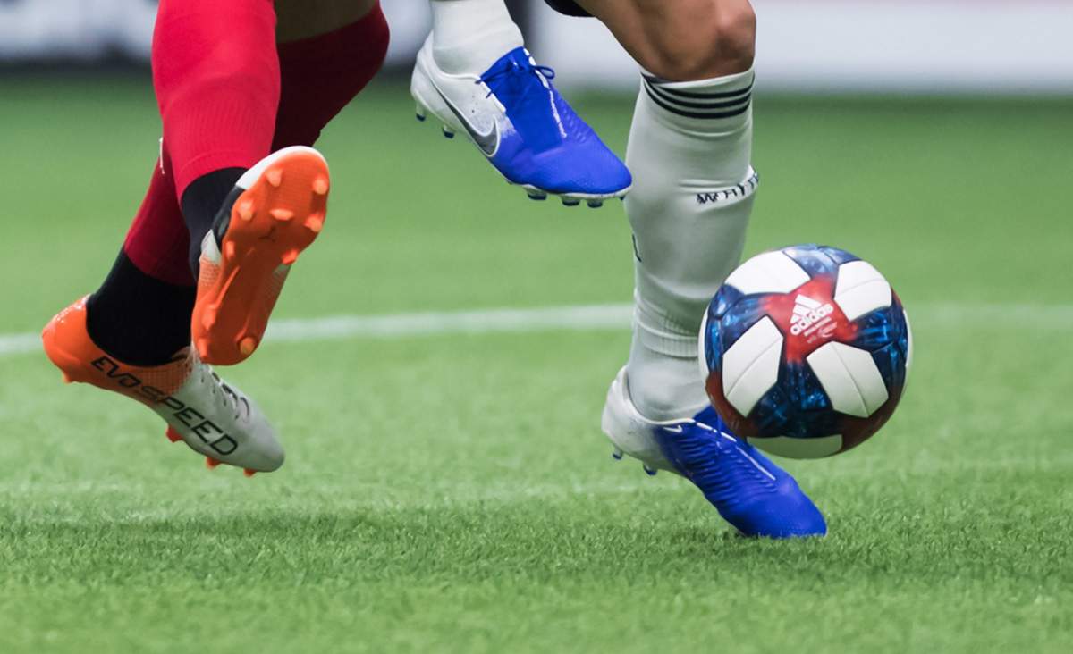 Toronto FC's Terrence Boyd, left, and Vancouver Whitecaps' Scott Sutter vie for the ball during the second half of an MLS soccer game in Vancouver on Friday May 31, 2019. 