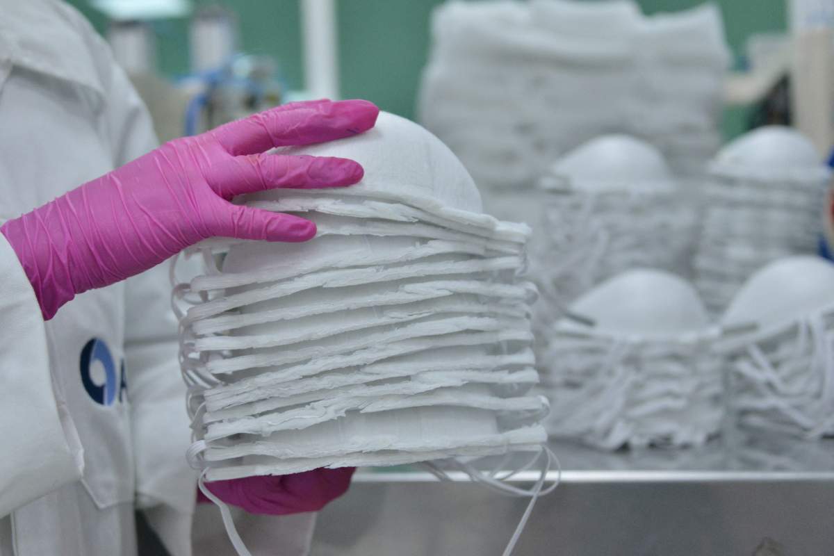 A worker wears a protective suit as precautionary measure while making an N95 mask at Atfil factory (High Technology in Air Filtration), Mexico City, Mexico, May 21, 2020.