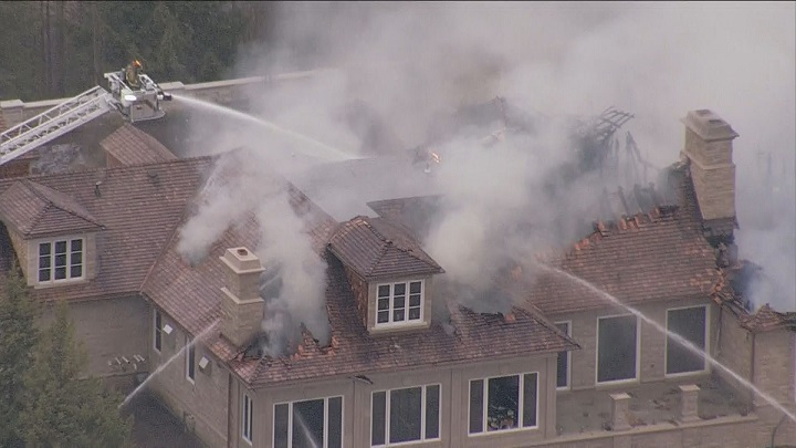 Firefighters on scene battling a fire at a home under construction in Aurora.