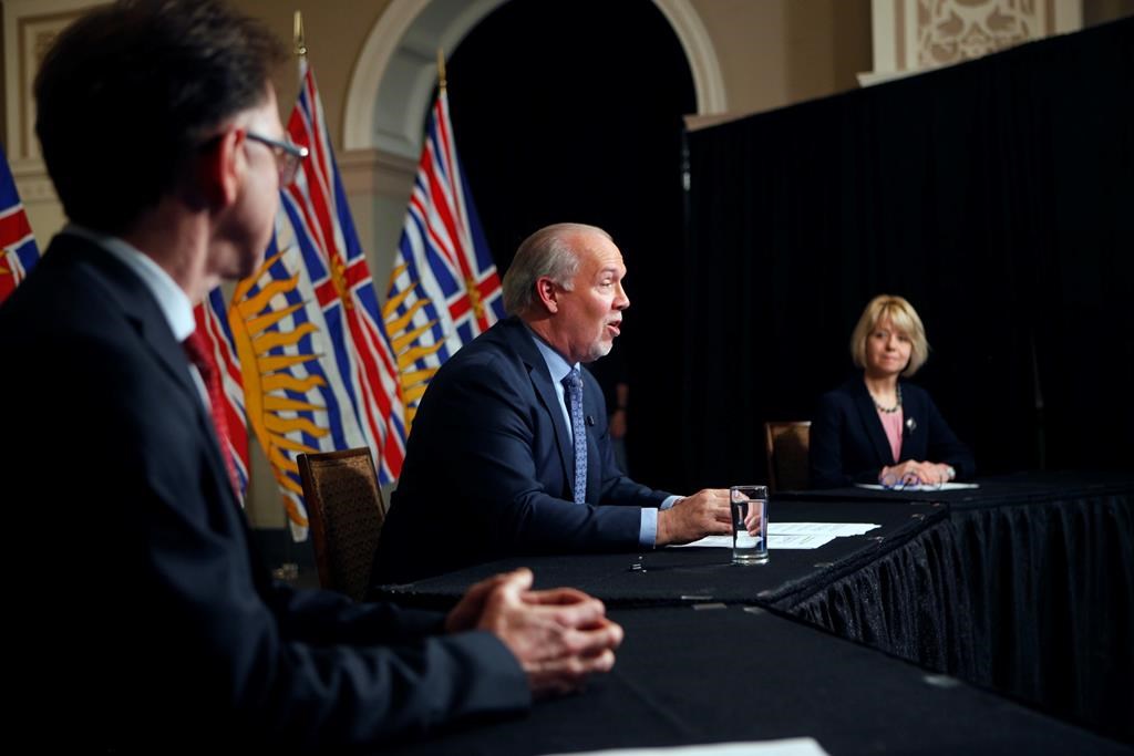 Premier John Horgan is joined by Provincial Health Officer Dr. Bonnie Henry and Health Minister Adrian Dix as they discuss reopening the province's economy in phases in response to the COVID-19 pandemic during a press conference in the rotunda at Legislature in Victoria, B.C., on Wednesday May 6, 2020.